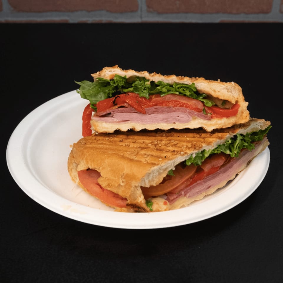 Tony's Panini Grill Hillside deli panini with meat, lettuce, tomatoes, and roasted red peppers.